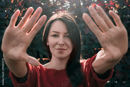 Fotomural Young beautiful woman enchantment. Stay away. Stop. Distance.