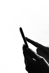 Woman hand holding a black smartphone in her hand. Teenage girl using a touchscreen smartphone, isolated on white