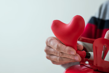 Wall Mural - inflating a heart-shaped balloon from a cylinder