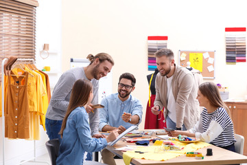 Fashion designers creating new clothes in studio