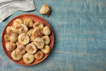 Canvas Print - Tasty dried figs on light blue wooden table, flat lay. Space for text