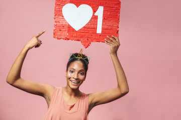 Wall Mural - Image of funny african american woman holding placard above her head