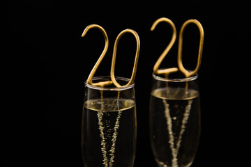 Two glasses of champagne on black background.