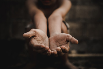 Wall Mural - poor child or beggar begging you for help sitting at dirty slum. concept for poverty or hunger people,human rights,donate and charity for underprivileged children in third world 