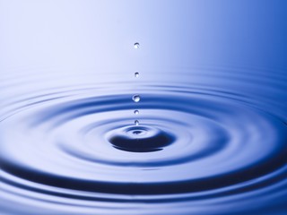  Drops hitting surface of water close-up