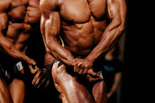 Athlete Bodybuilder Posing Biceps On Hand Of Bodybuilding Competition