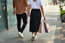 Young Happy Couple With Shopping Bags In The City.
