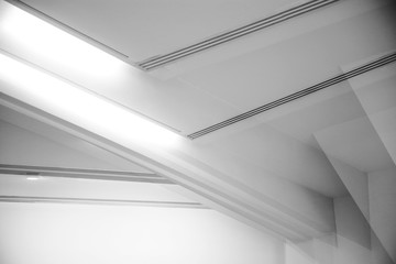 Poster - Computer graphics of abstract architecture fragment. Modern office building interior with polygonal white concrete girder elements of ceiling. Diagonal geometric composition in light gray color.
