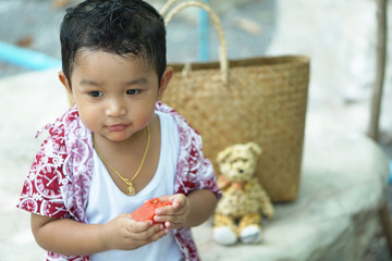 Wall Mural - Summer food. cheerful child eating juicy watermelon. Healthy eating seasonal fruits.do not Selective focus face photo.