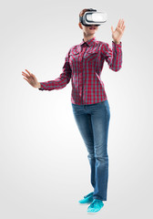 Poster - Young woman wearing VR goggles and gesturing