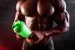 © thomsond - Torso of an African bodybuilder with a shaker in his hands on a black background