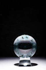 crystal ball with zodiac signs isolated on black