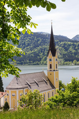 Saint Sixtus church Schliersee, chestnut branches, spring landscape bavaria