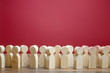 A crowd of wooden figures of people. Society, demography. Customers and buyers, statistics, preferences of Population. group of citizens, rally, political movement or electorate. Employees. Copy space