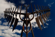 Morning Sun On Spirit Catcher Sculpture In Barrie Ontario Against A Blue Sky With Clouds
