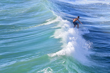 Man Surfing In Huntington Beach, CA
