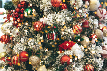 Christmas holiday tree with many balls and holiday lights. Christmas background.