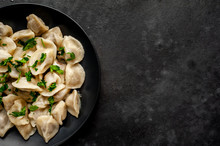 Dumplings With Spices And Herbs On A Stone Background With Copy Space For Your Text. Traditional Russian Dish - Dumplings