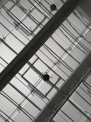 Poster - Ceiling of industrial or office building with metal girders and grid structures. Abstract black and white background on the subject of modern architecture, industry or business.
