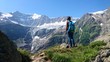 © ron - Hiker woman girl with backpack enjoying the mountains scenic view and the glaciers high alpine mountain trail climbing rest meditation switzerland