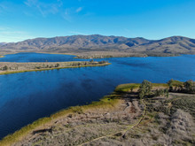 Aerial View Of Otay Lake Reservoir With Blue Sky And Mountain On The Background, Chula Vista, California. USA