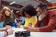 © Santi Nunez/Stocksy - Business group at a workshop in the office