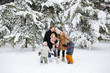 © Rob and Julia Campbell/Stocksy - Young family having fun togther in the snow.