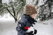© Rob and Julia Campbell/Stocksy - Young boy playing in the snow