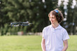 © Angela Lumsden/Stocksy - Teenage boy standing next to a flying drone