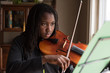 © Gabriel (Gabi) Bucataru/Stocksy - Black Girl Playing a Viola