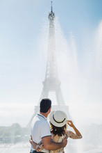 Unrecognizable Couple Looking At Eiffel Tower Near Fountain