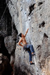 © Milles Studio/Stocksy - Muscular man climbing on cliff