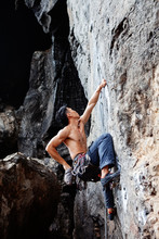 Athlete Hanging On Cliff