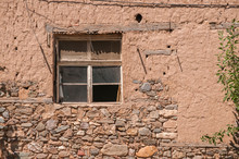 Old Weathered Broken Window On Neglected Adobe Clay Rural House Wall