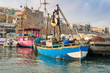 Port of Akko (Acre) with boats, mosque and the old city in the background, Israel.
