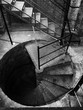 © Yakov Knyazev/Stocksy - Black and white spiral staircase in the old tower