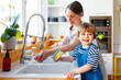 © Bonninstudio/Stocksy - Pregnant mom and son in the kitchen.