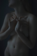 Women's Hands Bolt Up Their Breasts In Dark Light