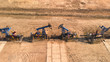 © Danil Nevsky/Stocksy - Oil wells in countryside extraction facility