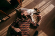 © Dmytro Bilous/Stocksy - the guy is lying on the floor with the dog and laughing
