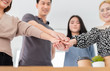 © jokekung - asian officer team holding hand together, they feeling cheerful and so happy, unity and teamwork, asian people prepare to group mission, happiness organization