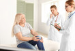 © Pixel-Shot - Doctors examining mature woman with joint pain in clinic