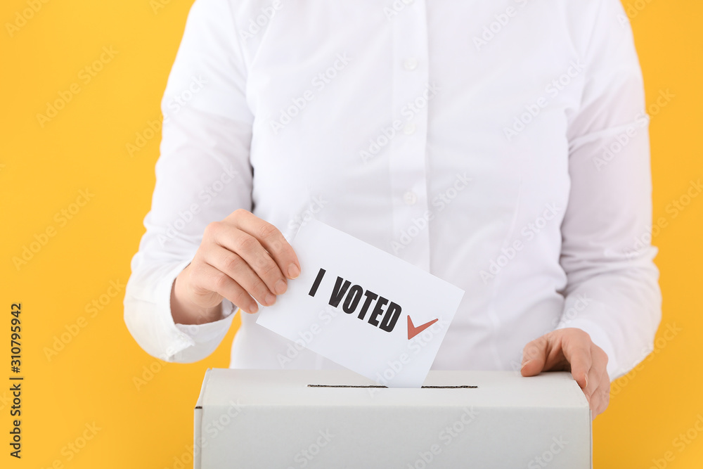 Voting woman near ballot box on color background