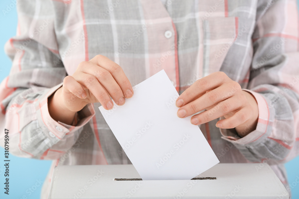 Voting woman near ballot box, closeup