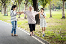 Asian Senior Woman Walking In A Straight Line,follow White Line On The Floor And Trying To Balance,elderly People Exercise With Arms Outstretched,testing And Risk Fall Prevention,balance The Body