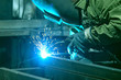 © zaktatyana - The welder performs welding work with semi-automatic arc welding. Welding stainless steel pipes. Welding MIG.
