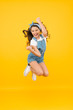 © be free - Active girl feel freedom. Fun and relax. feeling free. carefree kid on summer holiday. time for fun. retro beauty in mid air. Jump of happiness. small girl jump yellow background. full of energy.