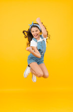 Active Girl Feel Freedom. Fun And Relax. Feeling Free. Carefree Kid On Summer Holiday. Time For Fun. Retro Beauty In Mid Air. Jump Of Happiness. Small Girl Jump Yellow Background. Full Of Energy.