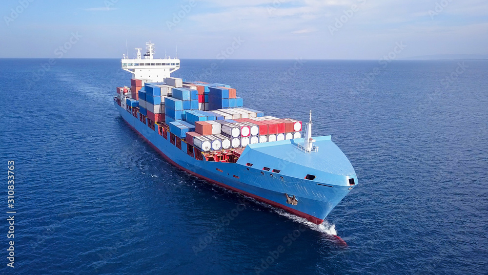 Large container ship at sea, loaded with various container brands. ULCV container ship sails on open water fully loaded with containers and cargo. - obrazy, fototapety, plakaty 