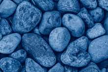 Closeup Macro Of Big Huge Large Blue Stones Rocks Pebbles Lying On Ground. Natural Eco Environmental Background Texture. View From Top Above. Toned With Classic Blue 2020 Colour.